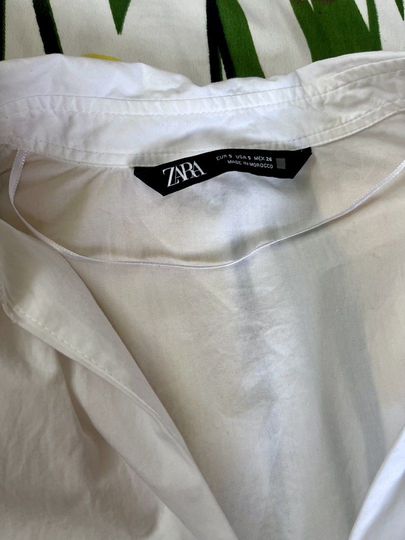 ZARA White Corset Style Button-Up Shirt (Category: Shirts) located in Manila. Submitted by oddstorm_9d6c74 (Listing ID 1441989760, Image 3). Description: - Zara white button-up shirt - Size S (estimated) - Corset-style fit with shaping darts - Long sleeves with button cuffs - Front zip closure.