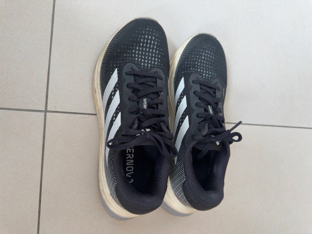 Adidas Supernova Running Shoes Black White (Category: Sneakers) located in Quezon City. Submitted by kikidc (Listing ID 1442297309, Image 2). Description: - Adidas Supernova running shoes - Color: Black with white stripes - Lightweight and comfortable for running - Laces are intact - Ready for your next run -Bought in 2024 and was rarely used.