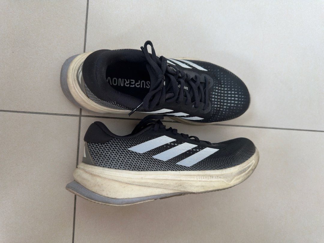 Adidas Supernova Running Shoes Black White (Category: Sneakers) located in Quezon City. Submitted by kikidc (Listing ID 1442297309, Image 1). Description: - Adidas Supernova running shoes - Color: Black with white stripes - Lightweight and comfortable for running - Laces are intact - Ready for your next run -Bought in 2024 and was rarely used.