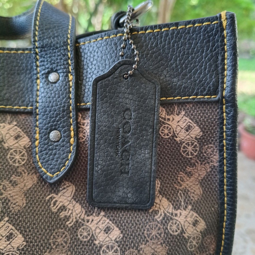 Authentic Coach Field Tote with Matching Pouch & Strap Set (Category: Luxury Bags & Wallets) located in Iloilo. Submitted by bellabeigefinds (Listing ID 1442257599, Image 3). Description: Selling a beautiful, complete Coach Field Tote Set in the iconic dark brown Horse and Carriage print with black pebble leather trim and contrast yellow stitching. Highly versatile and spacious, perfect for daily use, work, or school! What’s Included: •Main Field