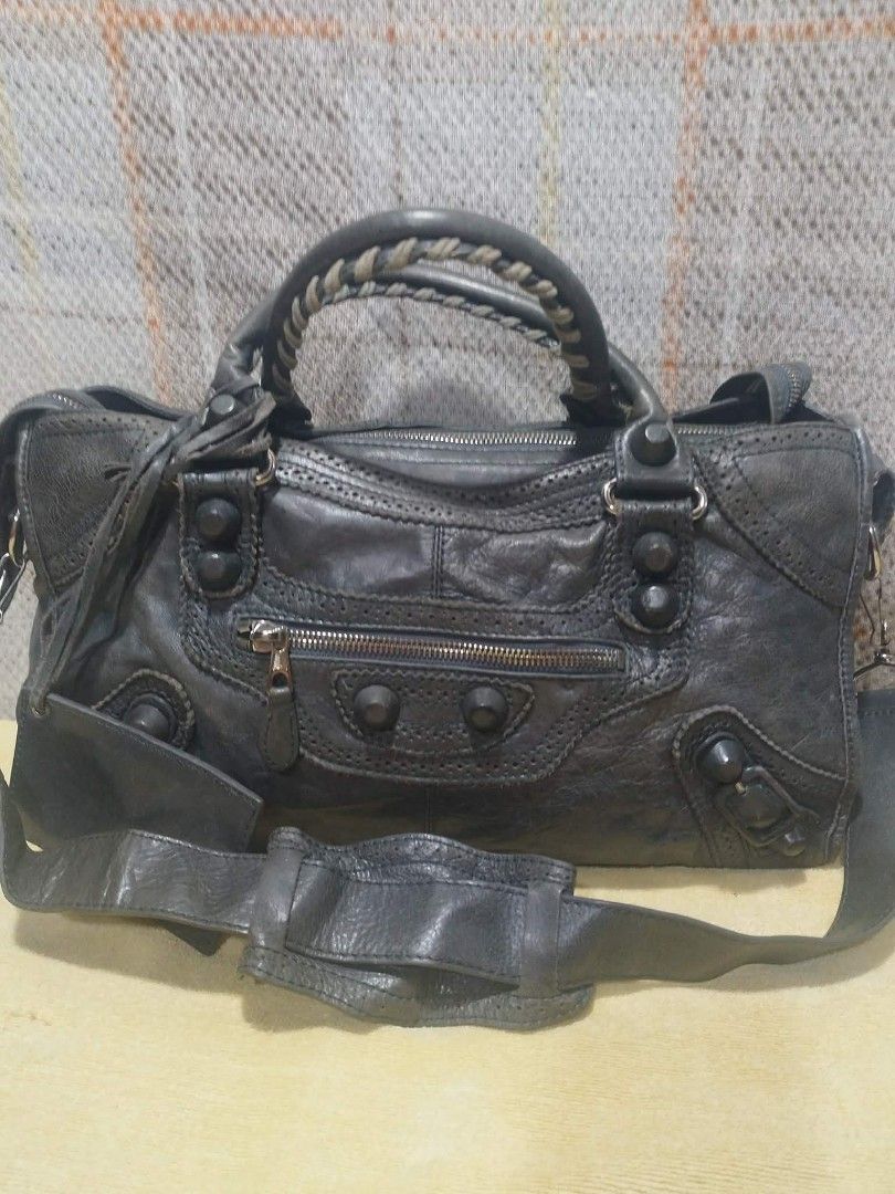 Balenciaga Paris Leather Handbag (Category: Luxury Bags & Wallets) located in Cebu City. Submitted by tlisurplus (Listing ID 1442290758, Image 1). Description: - Balenciaga Paris handbag - Color: Grey - Material: Distressed leather - Features: Braided handle, detachable shoulder strap, interior zip pocket - Origin: Made in Italy - Serial Number: 173082-200047.