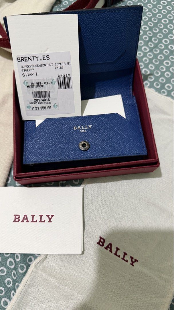 Bally Leather Wallet (Category: Luxury Bags & Wallets) located in Manila. Submitted by ronruiz17 (Listing ID 1419115113, Image 2). Description: - Authentic Bally black leather wallet - Includes original box (deep red color), dust bag (cream-colored), and card - Features the iconic Bally logo.