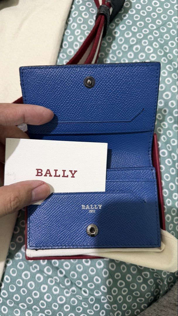 Bally Leather Wallet (Category: Luxury Bags & Wallets) located in Manila. Submitted by ronruiz17 (Listing ID 1419115113, Image 3). Description: - Authentic Bally black leather wallet - Includes original box (deep red color), dust bag (cream-colored), and card - Features the iconic Bally logo.