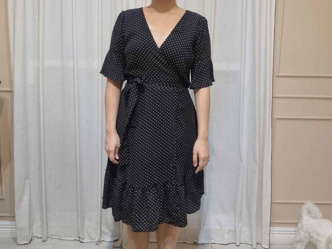 Black Polka Dot Wrap Dress with Ruffle Hem (Category: Dresses) located in Quezon City. Submitted by halylauren (Listing ID 1442310982, Image 2). Description: - Classic black dress with a fun white polka dot print. - Flattering wrap style with a tie waist. - Cute short flutter sleeves. - Adorable ruffle detail at the hem. - Versatile for casual outings or dressing up. - Effortless to wear and style..