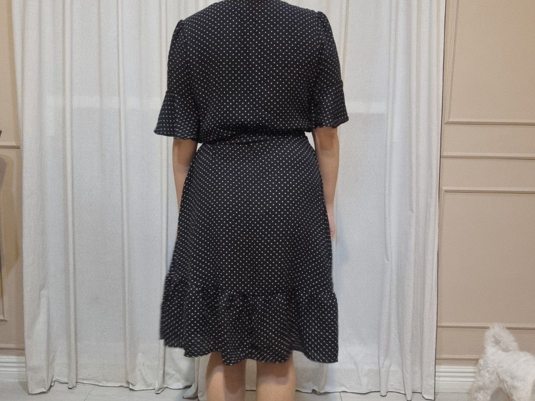 Black Polka Dot Wrap Dress with Ruffle Hem (Category: Dresses) located in Quezon City. Submitted by halylauren (Listing ID 1442310982, Image 3). Description: - Classic black dress with a fun white polka dot print. - Flattering wrap style with a tie waist. - Cute short flutter sleeves. - Adorable ruffle detail at the hem. - Versatile for casual outings or dressing up. - Effortless to wear and style..