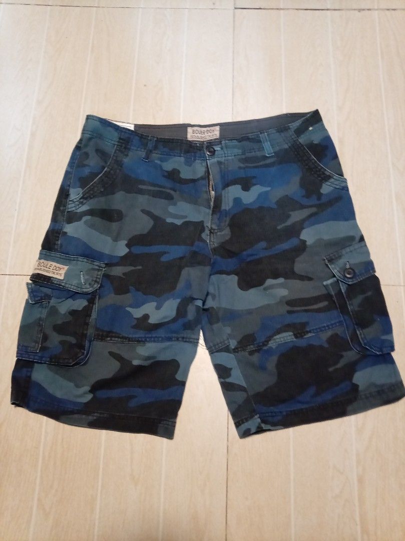 BOULE DOY Camouflage Cargo Shorts Size 36 (Category: Shorts) located in Manila. Submitted by sainty.exe (Listing ID 1442180937, Image 1). Description: - Brand: BOULE DOY - Size: 36 - Color/Pattern: Blue Camouflage 6 Pockets - Material: 60% Cotton, 40% Polyester - Features: Multiple side cargo pockets - Style: Casual wear.
