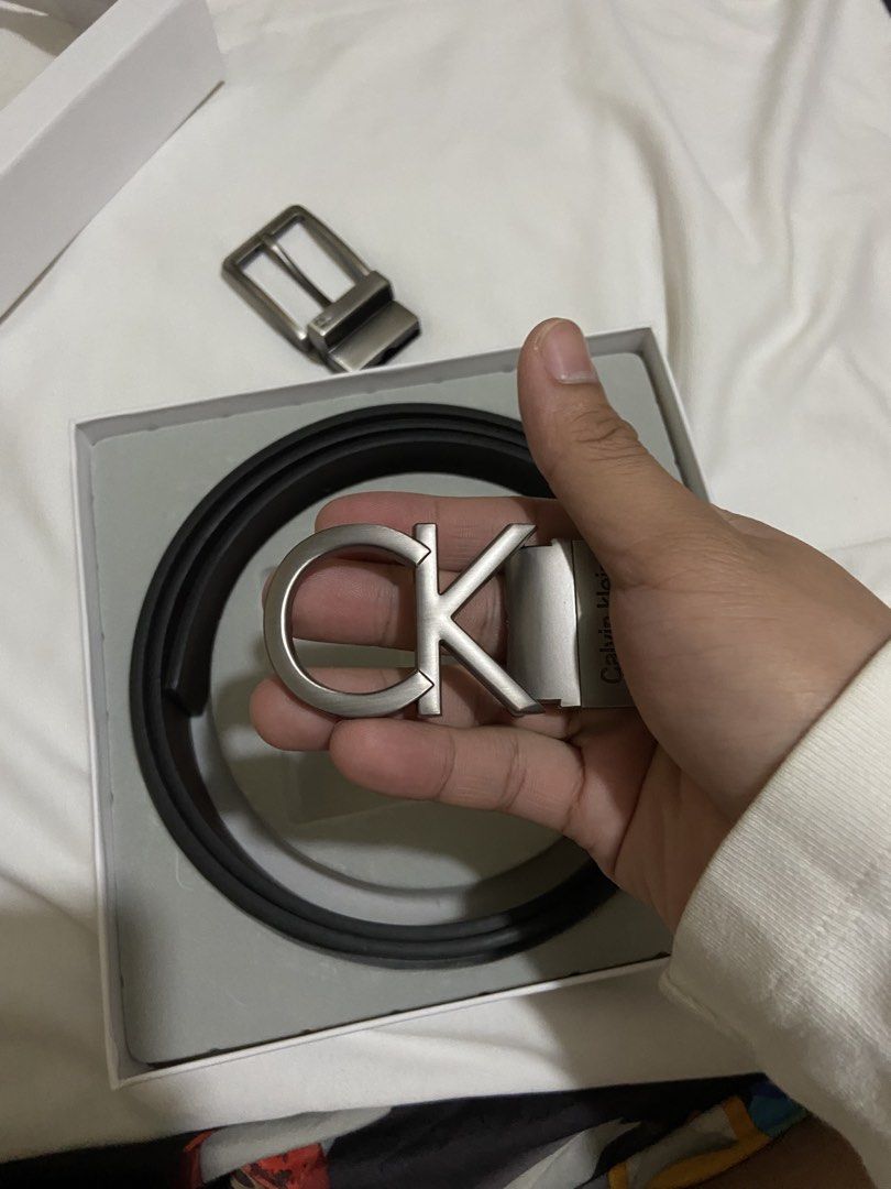 Calvin Klein Reversible Belt Set with 2 Buckles (Category: Belts) located in Manila. Submitted by adriyawnnn (Listing ID 1442170444, Image 3). Description: - Authentic Calvin Klein Belt Set - Reversible strap: Black on one side, Dark Brown on the other - Two interchangeable buckles included: - One with the iconic CK logo - One with 'Calvin Klein' name and a circular design - Versatile for different outfits and styles - Comes in its original Calvi