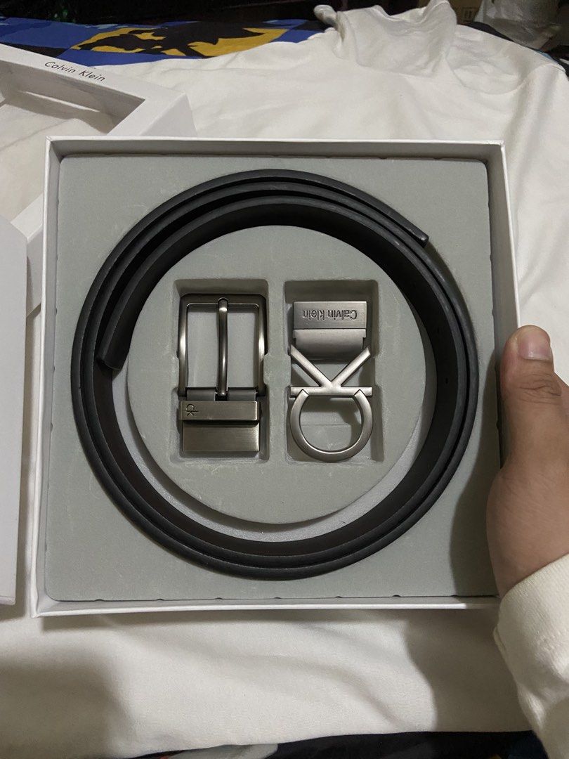 Calvin Klein Reversible Belt Set with 2 Buckles (Category: Belts) located in Manila. Submitted by adriyawnnn (Listing ID 1442170444, Image 2). Description: - Authentic Calvin Klein Belt Set - Reversible strap: Black on one side, Dark Brown on the other - Two interchangeable buckles included: - One with the iconic CK logo - One with 'Calvin Klein' name and a circular design - Versatile for different outfits and styles - Comes in its original Calvi