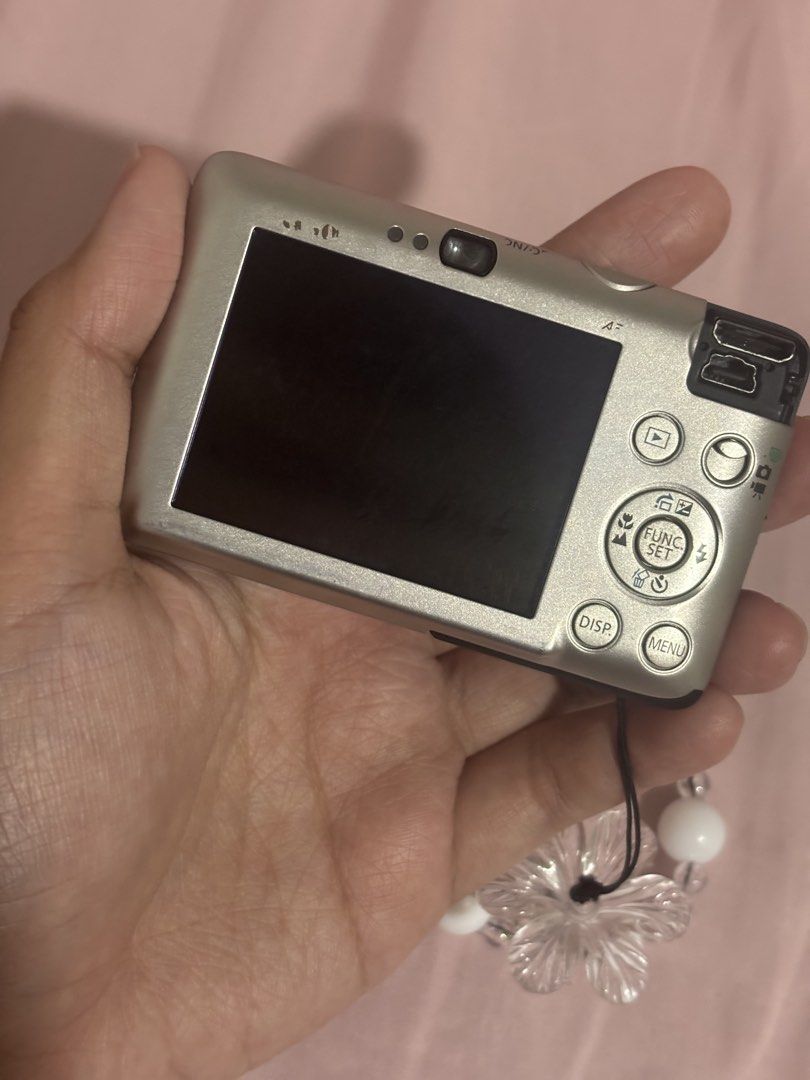 Canon Ixy 210 IS| Silver Digicam (Category: Cameras) located in Manila. Submitted by tlknam (Listing ID 1442156992, Image 3). Description: Canon Ixy 210 IS READY TO USE!! ✧˖°. body condi: 7/10 ✧˖°. 100% working – flash, zoom, video, buttons all functional ✧˖°. Issue: minimal lens dust + no port cover (for transparency) ✧˖°. comes with battery, charger, SD card, strap, and pouch Features: ✧˖°. 12.1 megapixels ✧˖°. 4x optical zoom (28mm wide) ✧˖°. 