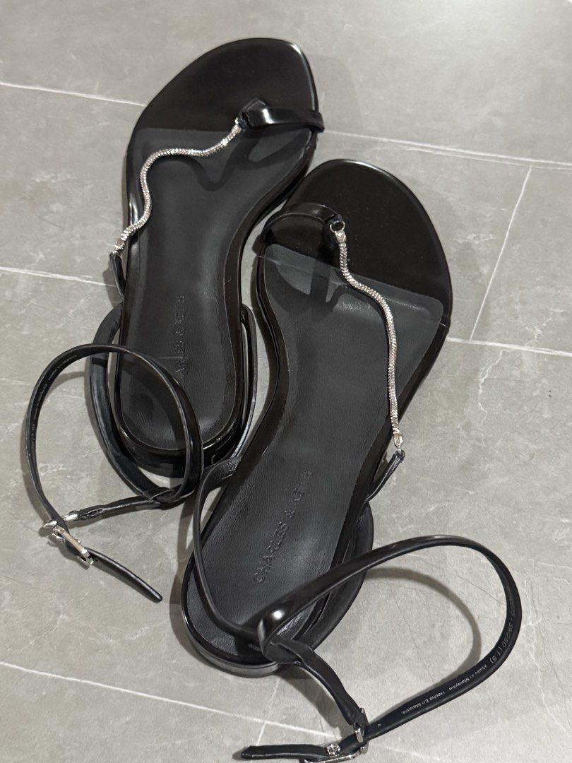 Charles & Keith Black Embellished Ankle Strap Sandals (Category: Flats & Sandals) located in Mandaluyong City. Submitted by ecowarriorph (Listing ID 1442286444, Image 2). Description: - Brand: Charles & Keith - Color: Black - Feature: Delicate chain detail across the front - Closure: Ankle strap with buckle - Sole: Flat - Style: Versatile, great for dressing up or down - Comfort: Comfortable for walking Original Price: 2,450 pesos Used twice only