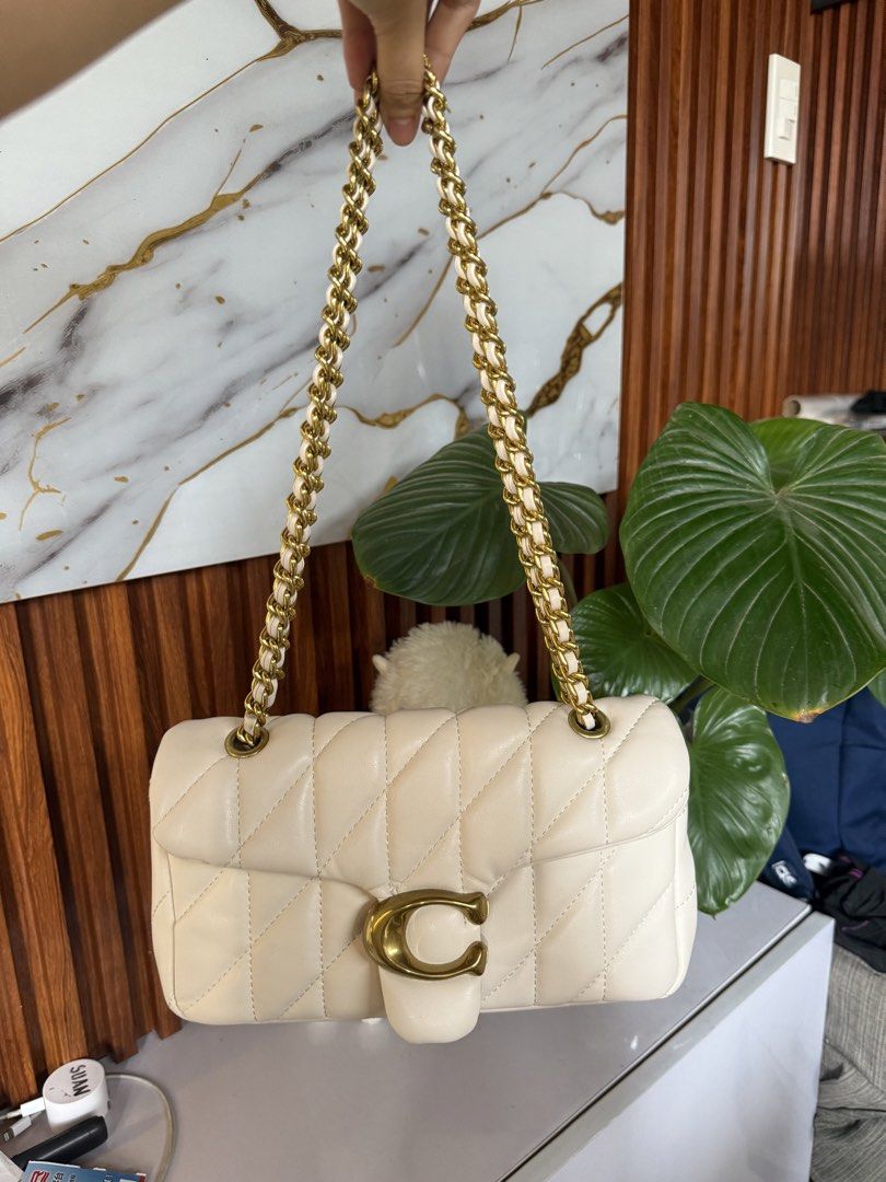 Coach Pillow Tabby Shoulder Bag (Category: Luxury Bags & Wallets) located in Marikina City. Submitted by declutter_keni24 (Listing ID 1442242899, Image 1). Description: - Cream colored Coach Pillow Tabby bag - Quilted leather with gold chain strap - Features signature C hardware - Interior is clean - Exterior has a few small marks on the side (shown in photos) Bought when I was in Japan. I bought on an online site. Used it few times it has some f