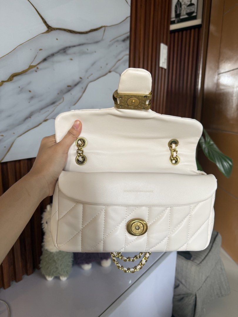 Coach Pillow Tabby Shoulder Bag (Category: Luxury Bags & Wallets) located in Marikina City. Submitted by declutter_keni24 (Listing ID 1442242899, Image 3). Description: - Cream colored Coach Pillow Tabby bag - Quilted leather with gold chain strap - Features signature C hardware - Interior is clean - Exterior has a few small marks on the side (shown in photos) Bought when I was in Japan. I bought on an online site. Used it few times it has some f