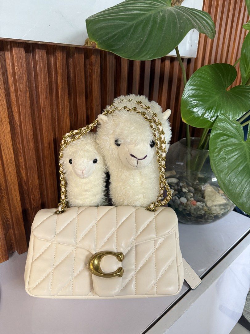 Coach Pillow Tabby Shoulder Bag (Category: Luxury Bags & Wallets) located in Marikina City. Submitted by declutter_keni24 (Listing ID 1442242899, Image 2). Description: - Cream colored Coach Pillow Tabby bag - Quilted leather with gold chain strap - Features signature C hardware - Interior is clean - Exterior has a few small marks on the side (shown in photos) Bought when I was in Japan. I bought on an online site. Used it few times it has some f