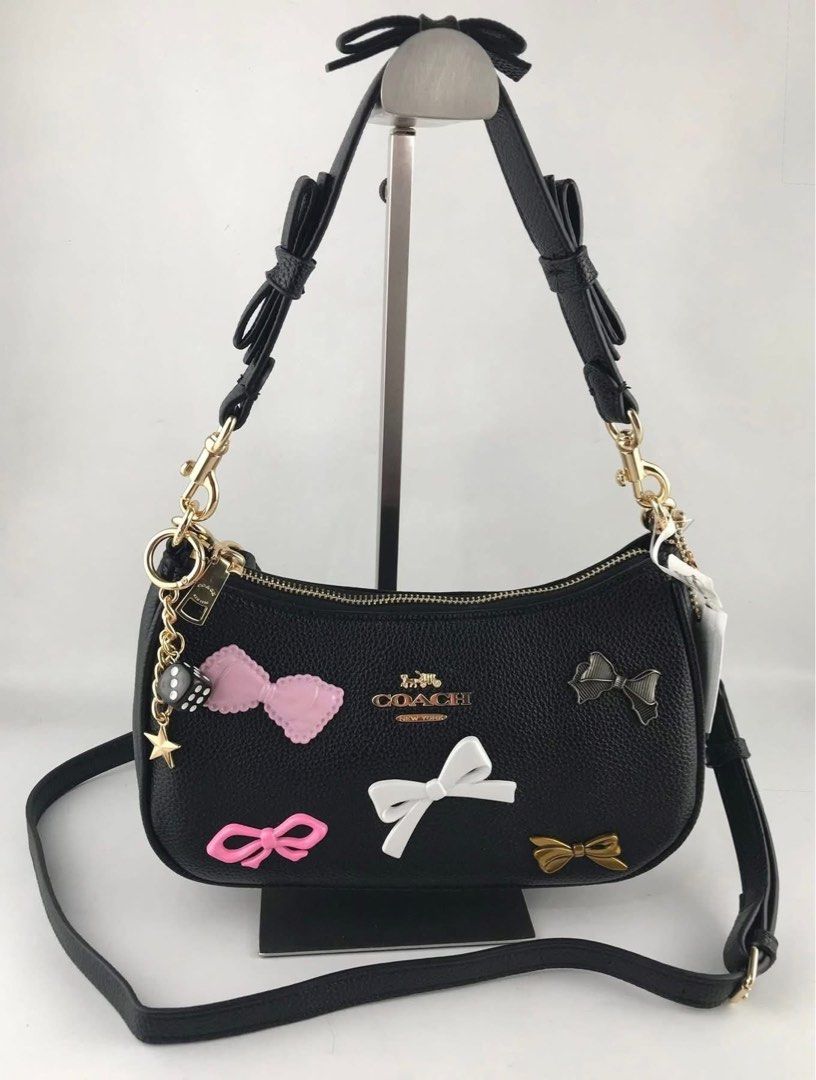 Coach Teri with bows & charms (Category: Luxury Bags & Wallets) located in Manila. Submitted by YSABELLE_MARGARETTE (Listing ID 1442205335, Image 2). Description: ONHAND! with tag, card, receipt, dustbag & paper bag j&t courier nationwide or lalamove around manila PAYMENT FIRST THRU GCASH!.