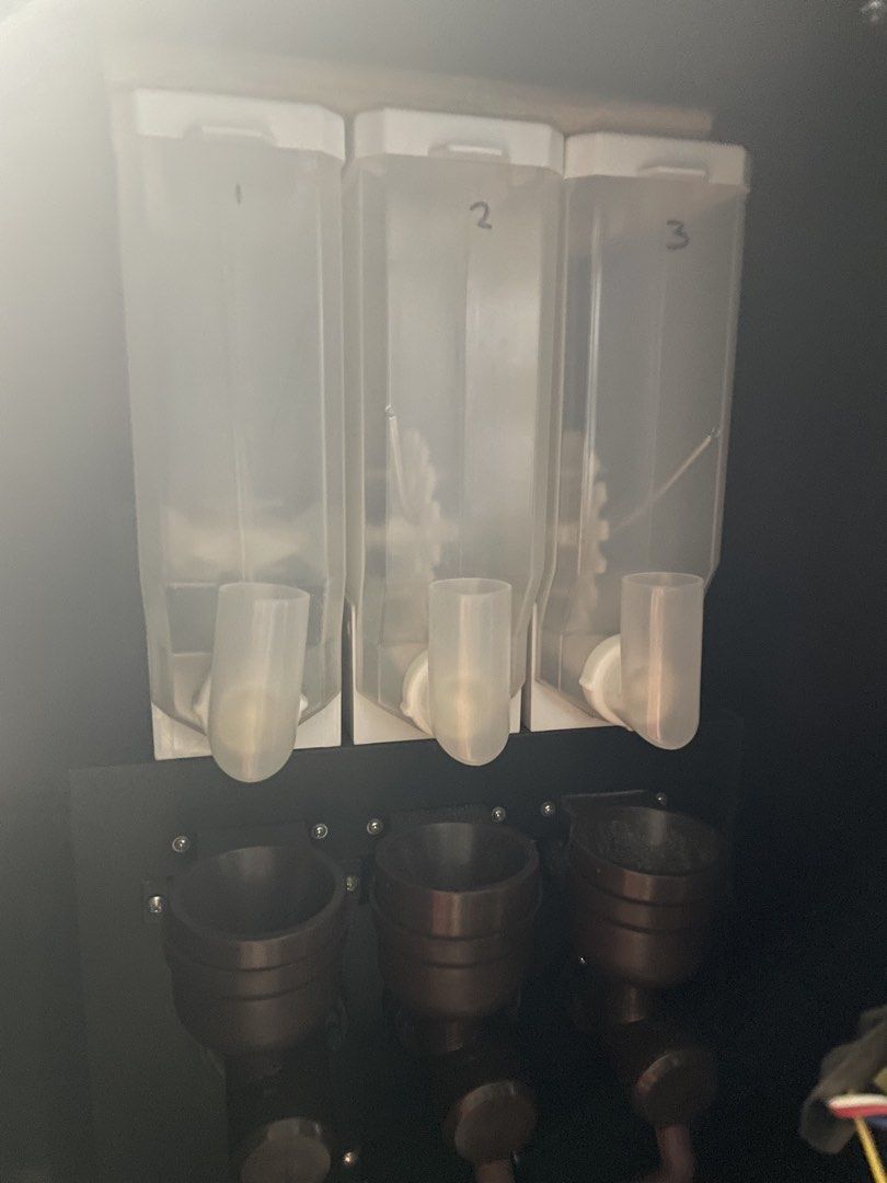 Coffee Vendo Machine Dosing Hoppers and Tubes (Category: Coffee Machines & Makers) located in Quezon City. Submitted by lanqcqc (Listing ID 1442189964, Image 2). Description: - Three dosing hoppers with connecting tubes - Likely for a commercial coffee machine - Features operational indicators: Mode Switch, Pull Handpiece Icon, Cleaning, and Cup Placement/Emptying.