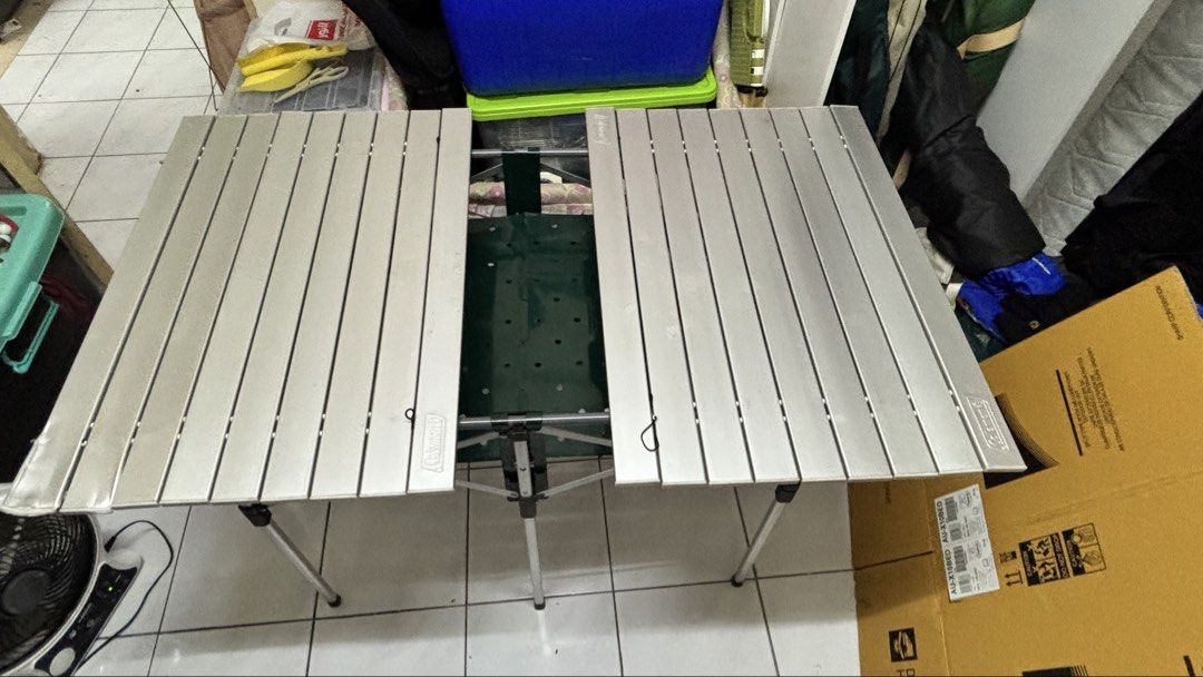 Coleman Camping Table with BBQ Space (Category: Hiking & Camping) located in Kuala Lumpur. Submitted by norkhalid158 (Listing ID 1442271798, Image 1). Description: Hrga boleh nego. Berminat boleh pm. Self pickup area ttdi grove kajang ada sedikit defect - Coleman table with integrated BBQ space - Custom frame structure - Ideal for outdoor activities and gatherings - Easy to set up and portable - Small defect due to usage.
