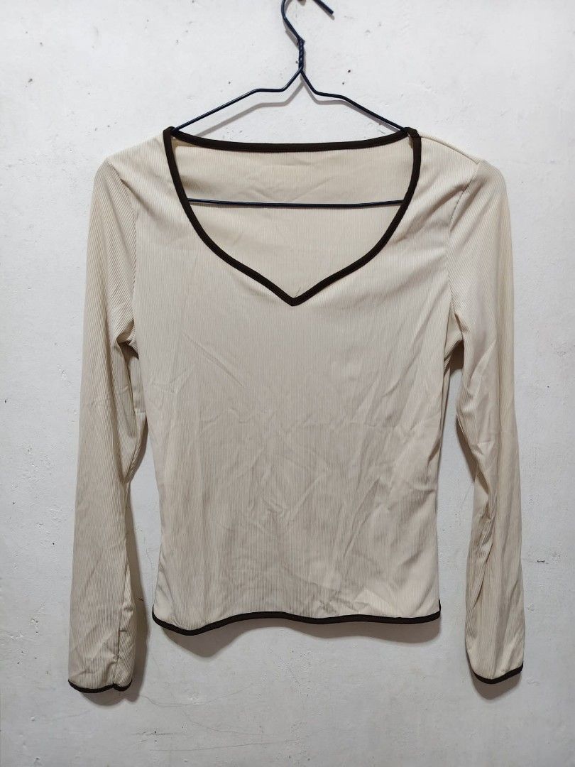 Cream Long Sleeve Top - L (Category: Longsleeves) located in Taguig. Submitted by phoopa (Listing ID 1442218426, Image 2). Description: - Cream long-sleeved top - V-neckline with dark trim - Dark trim on hem and cuffs - Simple and versatile design - Perfect for layering or wearing on its own.