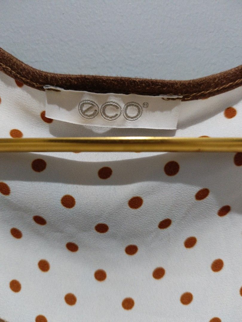ECO White Polka Dot Bell Sleeve Blouse (Category: Blouses) located in Manila. Submitted by lavu4555 (Listing ID 1442326846, Image 2). Description: - White blouse with charming brown polka dots - Features stylish bell sleeves - Round neckline with brown trim detail - Loose, flattering peplum fit - Tagged ECO, estimated size M or L - Ideal for everyday casual wear.