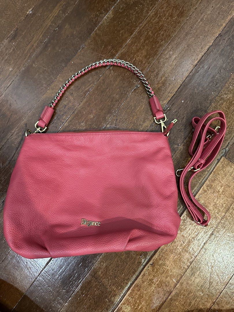 Elegance Pink Leather Shoulder Bag with Chain Strap (Category: Shoulder Bags) located in Del Monte. Submitted by bittersweetcigs (Listing ID 1442279777, Image 2). Description: - Pink leather shoulder bag by Elegance - Braided chain strap with leather accents - Top zipper closure - Back zipper pocket - Interior with patterned lining and logo patch - Detachable crossbody strap included - Ideal for everyday use.