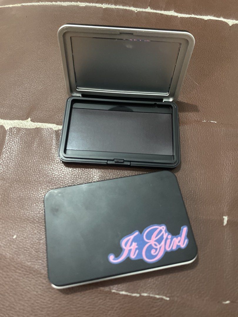 Empty Makeup Palette with Mirror ( ₱ 120 each) (Category: Makeup) located in Muntinlupa City. Submitted by lay_away_ok (Listing ID 1442158662, Image 1). Description: - Empty black makeup palette with a built-in mirror. - Decorated with 'It Girl' and 'The Pretty Girl Mantra' stickers. - Ideal for creating your own custom eyeshadow or blush palettes. - Compact and portable for easy carrying. - Perfect for travel or daily touch-ups..