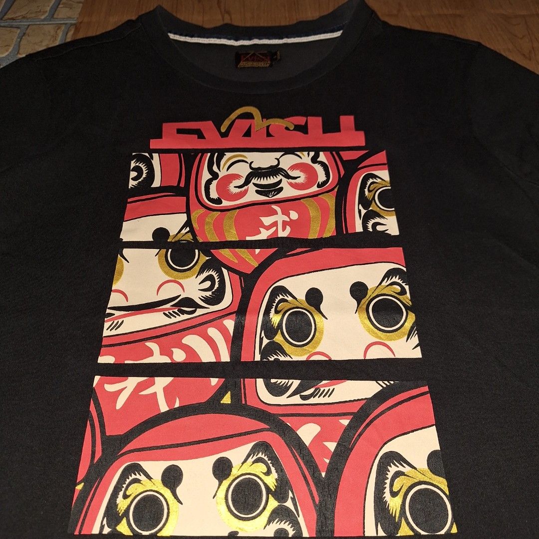 Evisu Daruma Printed Shirt (Category: Tshirts & Polo Shirts ) located in Aroroy. Submitted by rewear_r3volution (Listing ID 1442332470, Image 2). Description: This is an EVISU black t-shirt featuring a prominent Daruma doll graphic on the front..