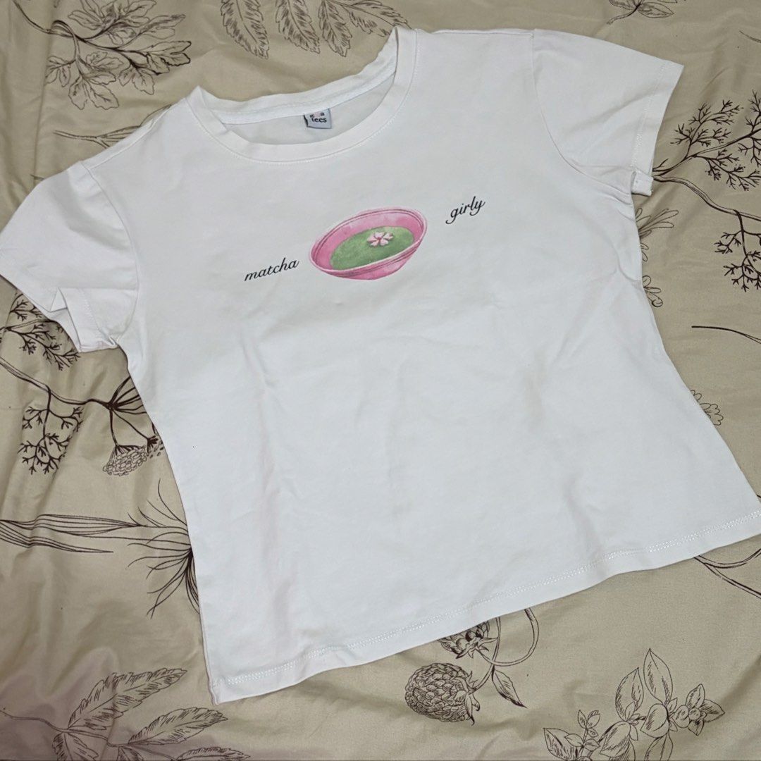 Graphic White Matcha Girly Baby Tee (Category: Shirts) located in Bambang. Submitted by gigisells_ (Listing ID 1442281569, Image 2). Description: xs-m from girl all might tees cotton material.