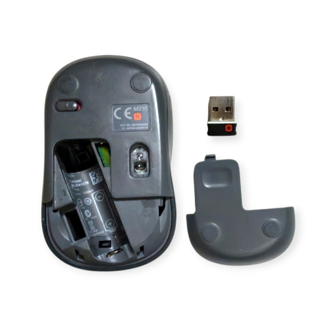 Grey Logitech M235 wireless mouse. It operates using a single AA battery for power. The device includes a USB Nano receiver for wireless connectivity.474898573517148161