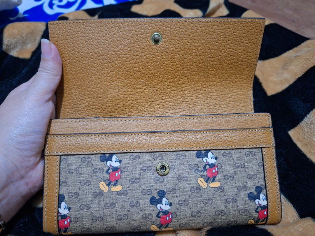 Gucci x Disney Mickey Mouse Wallet (Category: Luxury Bags & Wallets) located in Taguig. Submitted by maygm72703 (Listing ID 1442200686, Image 3). Description: - Features the iconic GG monogram pattern - Comes with original Gucci box and dust bag - Interior includes multiple card slots and a secure zippered compartment - A unique and stylish accessory for Disney and Gucci enthusiasts - Japan sourced .
