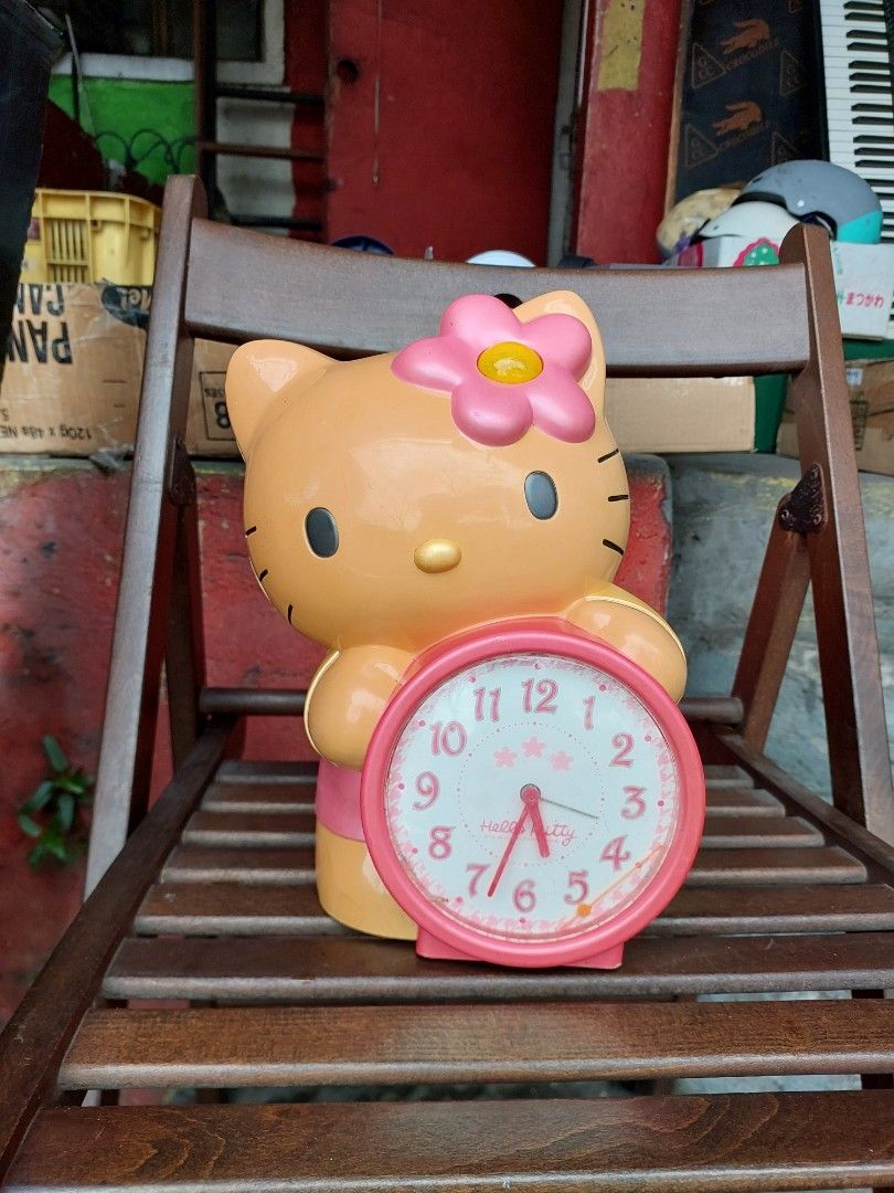 Hello Kitty Alarm Clock with Pink Bow and Flower (Category: Clocks) located in Quezon City. Submitted by jpnvintageonline (Listing ID 1442159868, Image 3). Description: - Vintage HELLO Kitty alarm clock - Features a cute pink bow and flower detail - Pink clock face with red hands - Battery operated - Perfect for any Kitty fan's room - Shows minor signs of wear on the plastic casing - NOT working.
