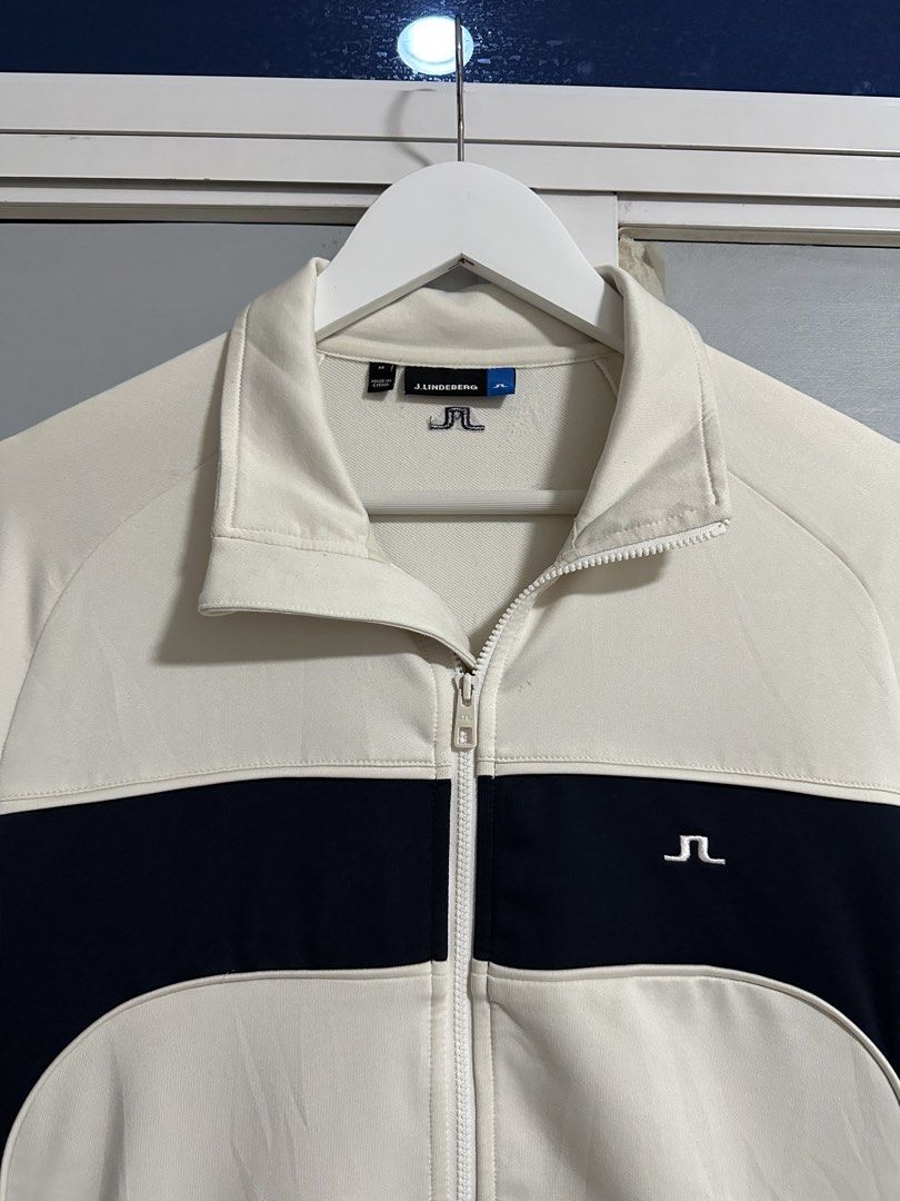 J. Lindeberg Zip Up Jacket Cream Navy (Category: Coats, Jackets and Outerwear) located in Pasig City. Submitted by rl.things (Listing ID 1442189377, Image 2). Description: - J. Lindeberg cream and navy zip-up jacket - Features J. Lindeberg logo on the chest - Full zip closure - Two side pockets - Ideal for layering or as a light jacket.