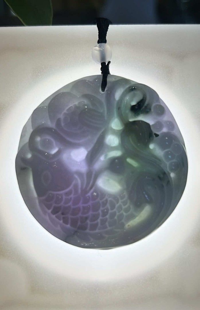 Jadeite Purple and Green Pendant (Category: Necklaces) located in Taguig. Submitted by c_rivera (Listing ID 1442234835, Image 3). Description: Front carving, Koi, Lotus. Purple with green color. Transluscent and very jelly. Has a brown rope necklace and will come with a stand to display while not being worn. very nice piece. letting go because I have another one I like better and jade is better when used often! for protection, balance, wealth and