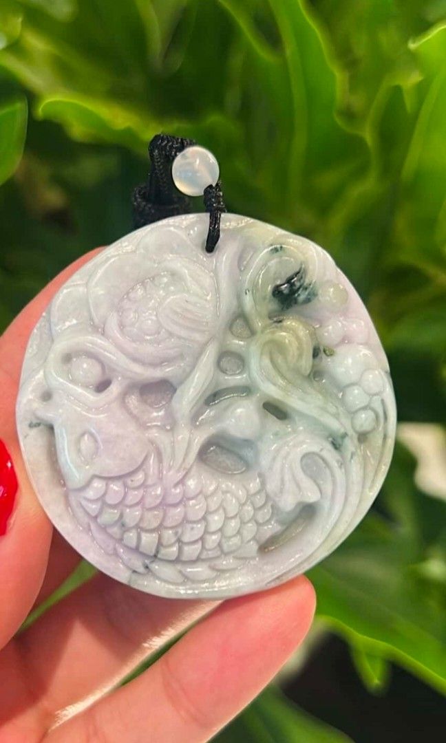 Jadeite Purple and Green Pendant (Category: Necklaces) located in Taguig. Submitted by c_rivera (Listing ID 1442234835, Image 1). Description: Front carving, Koi, Lotus. Purple with green color. Transluscent and very jelly. Has a brown rope necklace and will come with a stand to display while not being worn. very nice piece. letting go because I have another one I like better and jade is better when used often! for protection, balance, wealth and