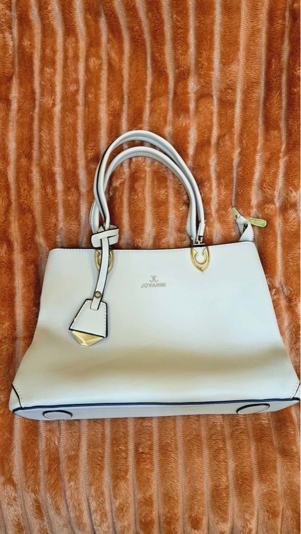 JOVANNI White Structured Tote Bag with Gold Hardware (Category: Tote Bags) located in Manila. Submitted by flicker_33 (Listing ID 1442311137, Image 1). Description: - White structured tote bag by JOVANNI - Elegant gold hardware details - Multiple interior compartments for easy organization - Comfortable top handles for carrying - Includes a detachable charm - Generous size: approximately 14 inches wide.
