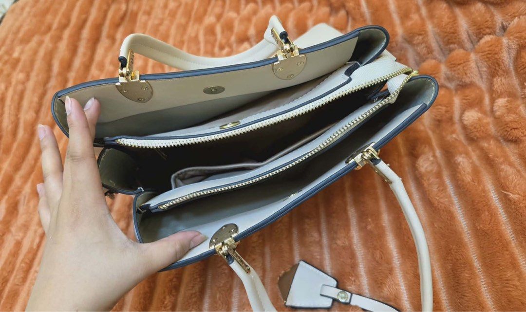 JOVANNI White Structured Tote Bag with Gold Hardware (Category: Tote Bags) located in Manila. Submitted by flicker_33 (Listing ID 1442311137, Image 2). Description: - White structured tote bag by JOVANNI - Elegant gold hardware details - Multiple interior compartments for easy organization - Comfortable top handles for carrying - Includes a detachable charm - Generous size: approximately 14 inches wide.