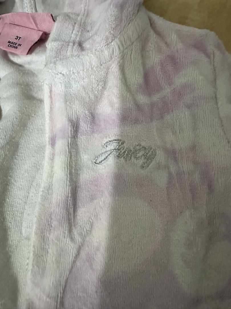 Juicy Couture Velour Hoodie Tie-Dye Lilac White (Category: Coats, Jackets and Outerwear) located in Manila. Submitted by jessj30 (Listing ID 1442263493, Image 2). Description: - Soft velour Juicy Couture hoodie - Trendy lilac and white tie-dye pattern - Convenient zip-up front with pockets - Ribbed cuffs and hem for a comfortable fit - Ideal for everyday casual wear.