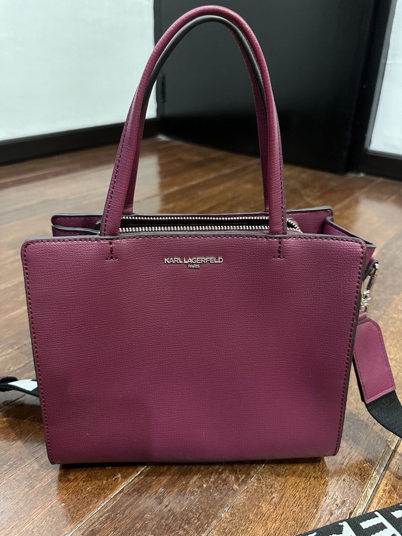 Karl Lagerfeld Paris Tote Bag with Strap (Category: Tote Bags) located in Del Monte. Submitted by bittersweetcigs (Listing ID 1442279369, Image 3). Description: - Authentic Karl Lagerfeld tote bag - Chic purple color - Versatile top handles and detachable crossbody strap - KARL LAGERFELD PARIS branded strap - Secure zipper closure - Multiple interior compartments for organization - Ideal for everyday use.