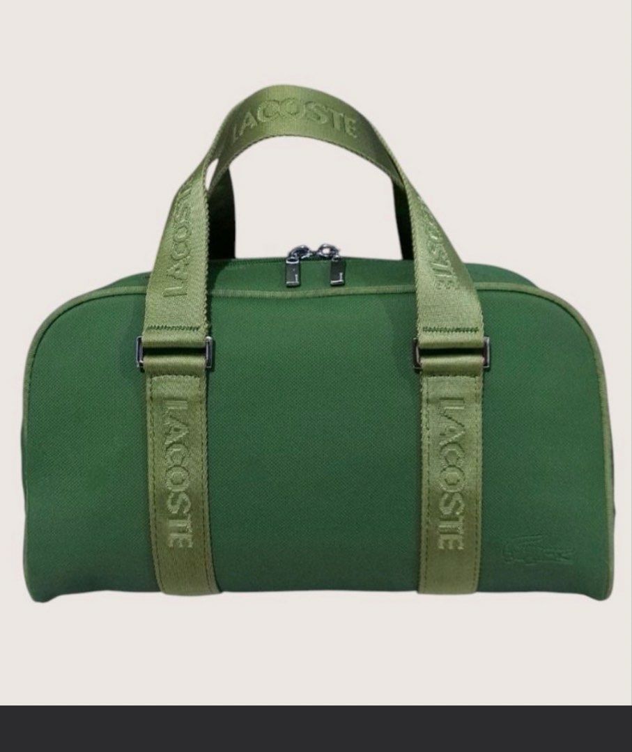 Lacoste Green Duffel Bag (Category: Luxury Bags & Wallets) located in Manila. Submitted by devorahlop39116 (Listing ID 1442215385, Image 1). Description: - Green Lacoste duffel bag - Lacoste logo detail on straps - Zippers are in good working condition - Interior features a small pocket with a clip - Ideal size for weekend getaways or gym sessions - Bag is clean outside Only issue is my few stains sa loob Buyer will shoulder the shipping fee Last