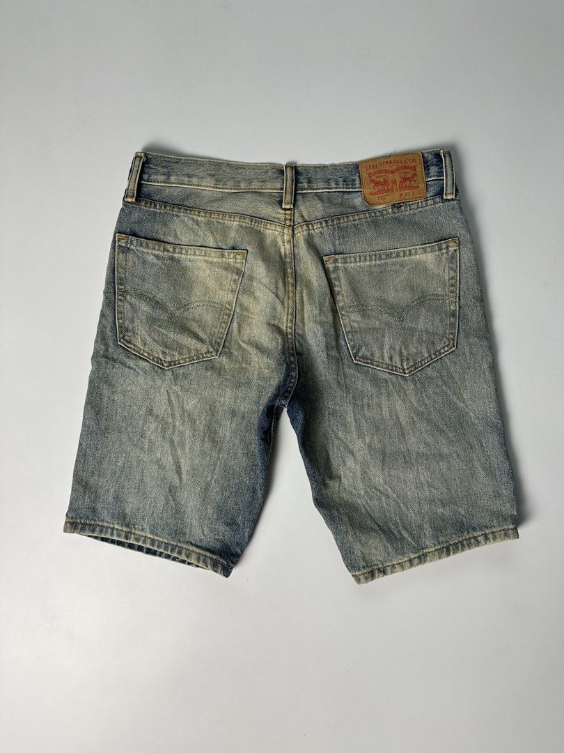 Levis 502 W32 Tattered Denim Shorts (Category: Shorts) located in Mabalacat. Submitted by shiroe14 (Listing ID 1442255476, Image 2). Description: - Brand: Levis - Model: 502 - Size: W32 - Style: Tattered Denim Shorts - Color: Light Blue Wash - Features: Tattered details, iconic Levis branding - Issue: minimal stain - Dimes(inches): 34 waist x 20 length x 9 leg open.
