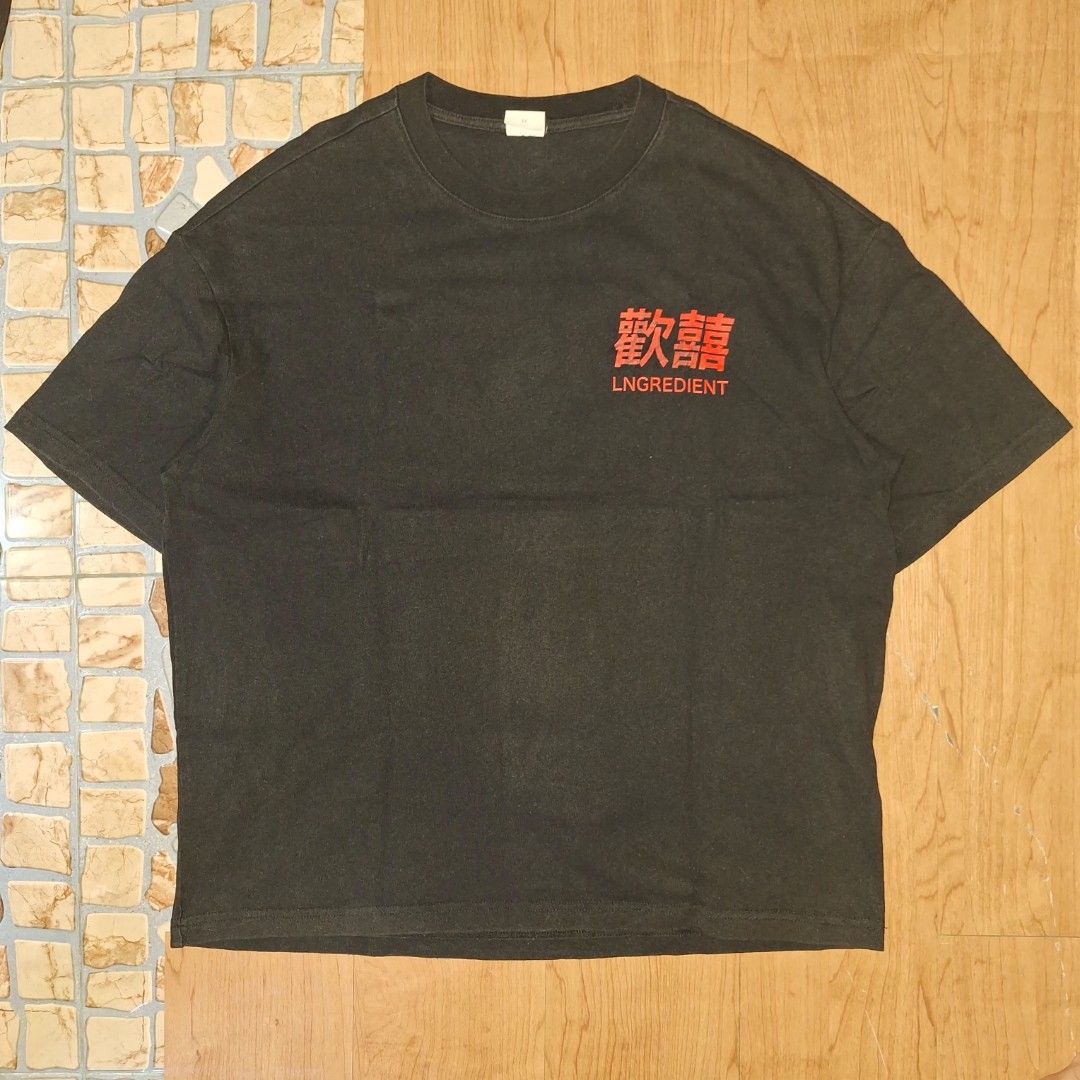 Lngredient Big Graphic Tee. (Category: Tshirts & Polo Shirts ) located in Aroroy. Submitted by rewear_r3volution (Listing ID 1442333364, Image 2). Description: This is a black graphic t-shirt featuring a Japanese-inspired art style, specifically depicting a child wearing a white Stussy bucket hat. Size Medium.