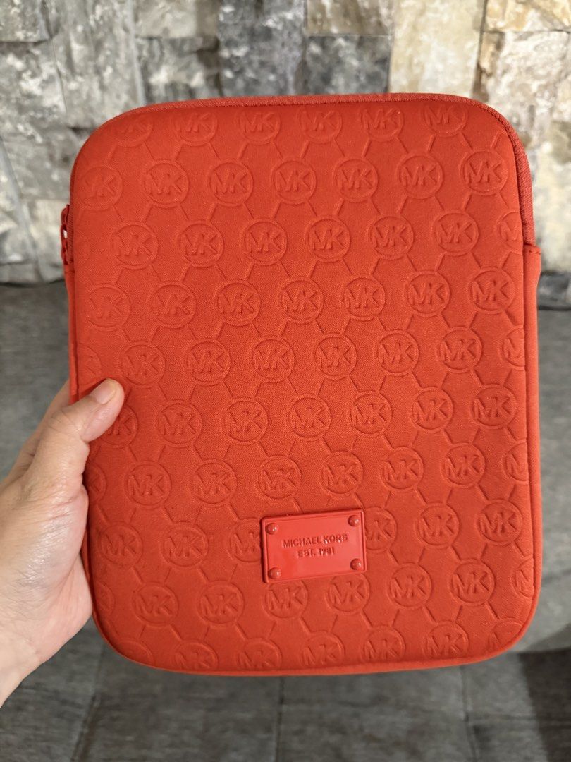 Michael Kors MK Tablet Case (Category: Cases & Sleeves) located in Paranaque City. Submitted by mareese1922 (Listing ID 1442248454, Image 2). Description: - Orange Michael Kors tablet sleeve - Ideal for protecting your tablet - Dimensions are in the photos - iPad mini for size reference only and NOT INCLUDED 😅 Loc: Paranaque.