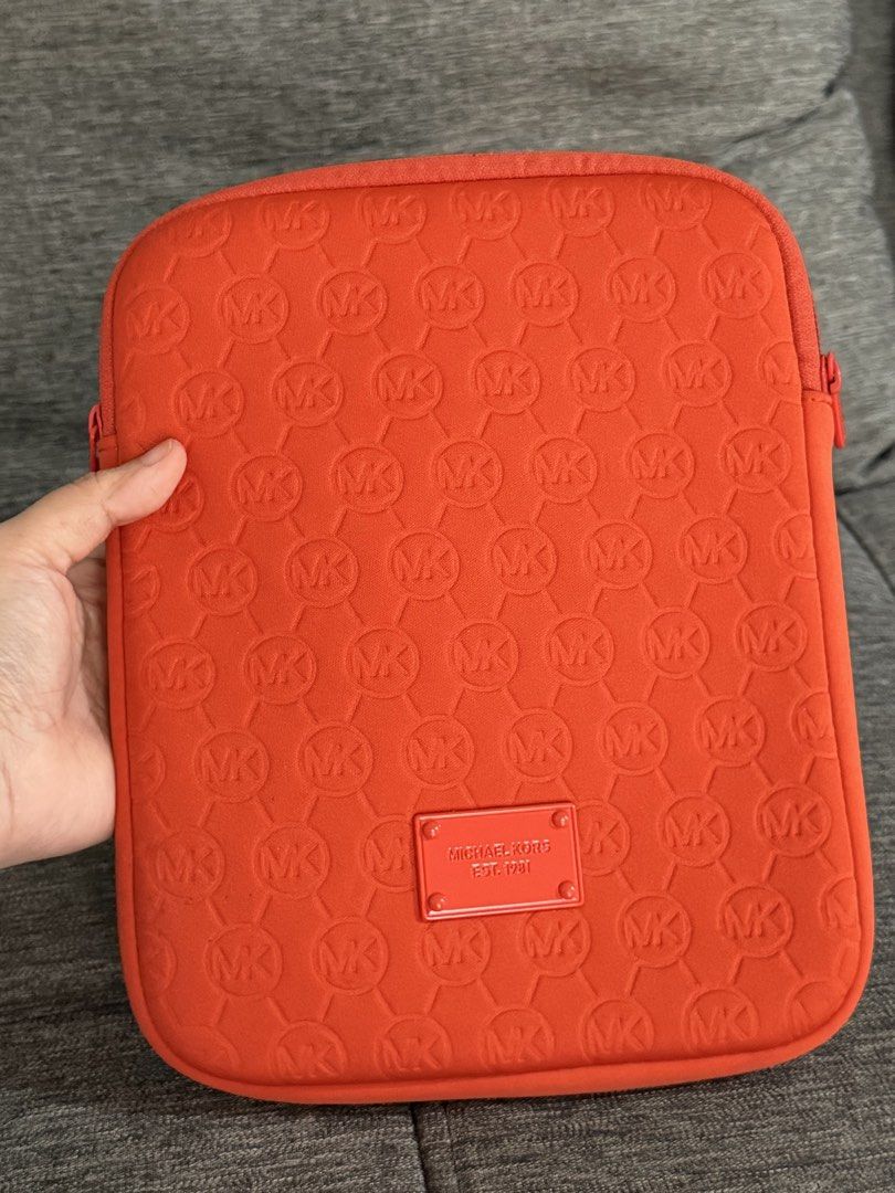 Michael Kors MK Tablet Case (Category: Cases & Sleeves) located in Paranaque City. Submitted by mareese1922 (Listing ID 1442248454, Image 1). Description: - Orange Michael Kors tablet sleeve - Ideal for protecting your tablet - Dimensions are in the photos - iPad mini for size reference only and NOT INCLUDED 😅 Loc: Paranaque.