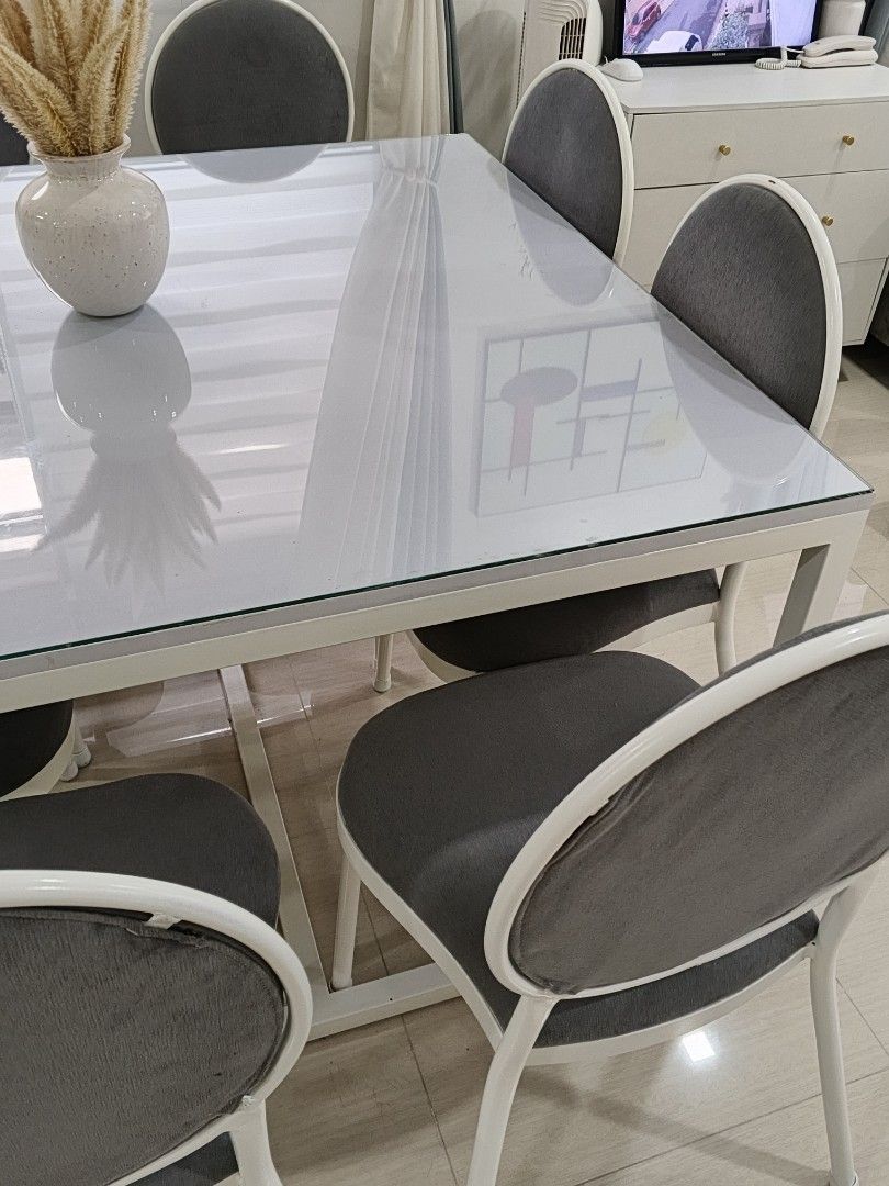 Modern White Dining Table with 8 Gray Chairs (Category: Tables & Sets) located in Quezon City. Submitted by the_answer_3 (Listing ID 1442289318, Image 3). Description: - Sleek modern white dining table with white metal legs. - Includes 8 comfortable gray upholstered chairs with white metal frames. - Seats 6 people comfortably. - Ideal for family meals and entertaining guests. - Sold as a complete set. loc: Batasan Hills Q.C..