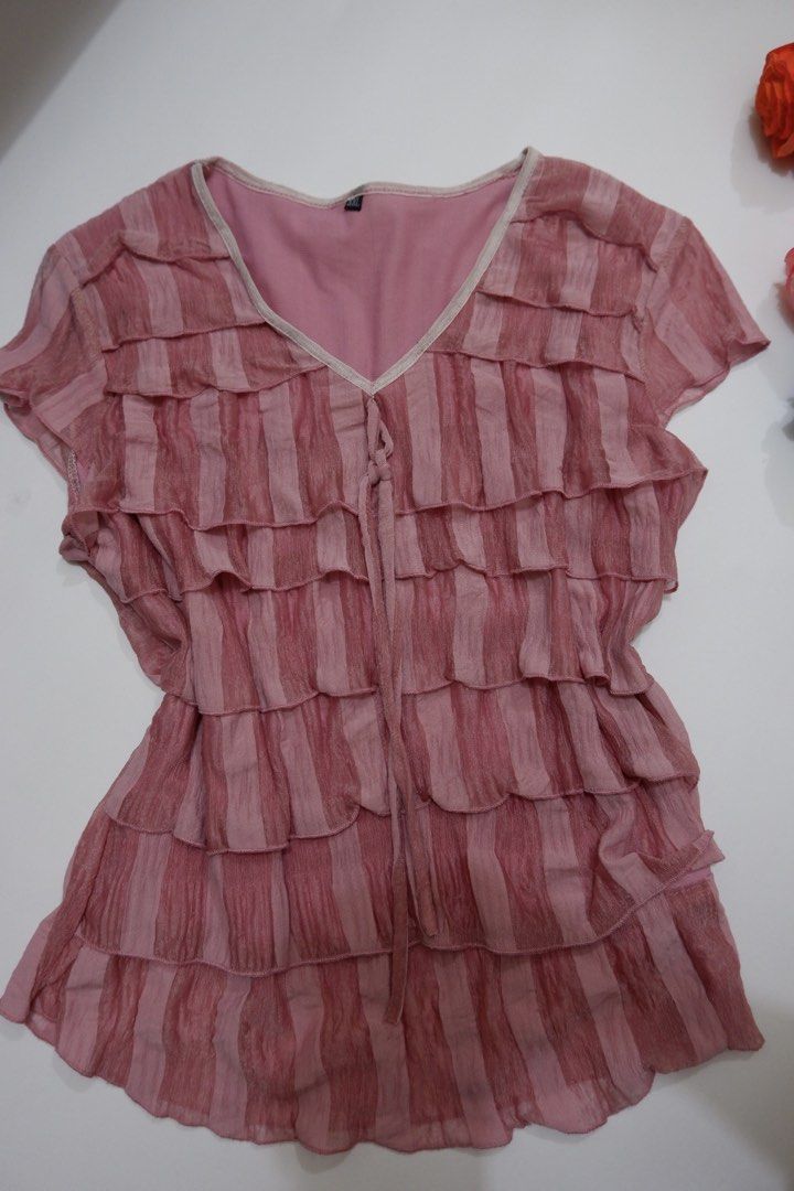 Pink Ruffle V-Neck Short Sleeve Top (Category: Blouses) located in Pasig City. Submitted by mjca29 (Listing ID 1442236581, Image 3). Description: Pink top with charming all-over ruffles. The size on tag is not accurate. Size: Small *Manage your expectation. Pre-loved item *Color may vary due to lighting SF will shouldered by buyer .