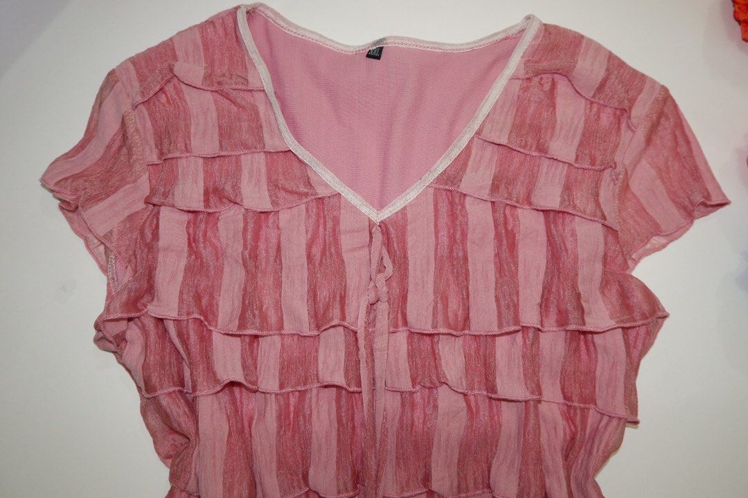 Pink Ruffle V-Neck Short Sleeve Top (Category: Blouses) located in Pasig City. Submitted by mjca29 (Listing ID 1442236581, Image 2). Description: Pink top with charming all-over ruffles. The size on tag is not accurate. Size: Small *Manage your expectation. Pre-loved item *Color may vary due to lighting SF will shouldered by buyer .
