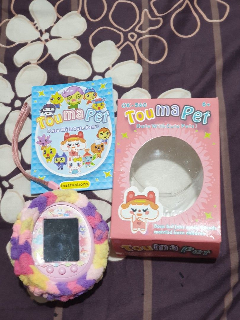 PINK TAMAGOTCHI ELECTRONIC PET TOY WITH FLUFFY COVER (Category: Interactive Toys) located in Malabon City. Submitted by toughMeg (Listing ID 1442243633, Image 2). Description: PINK TAMAGOTCHI ELECTRONIC PET TOY WITH FLUFFY COVER ‼have slightly scratch on screen and minimal rust on battery holder pls see photos..