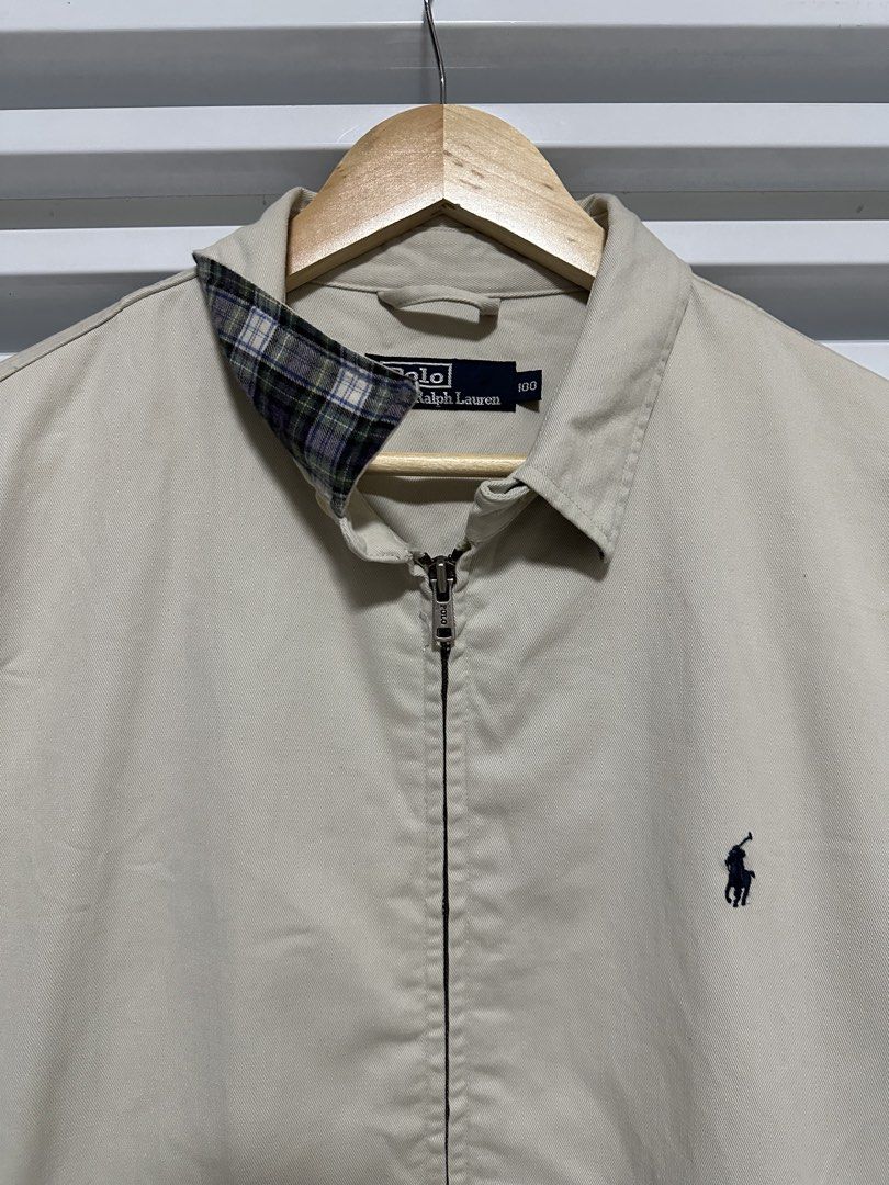Polo Ralph Lauren Harrington Jacket Beige (Category: Fragrance & Deodorants) located in Pasig City. Submitted by rl.things (Listing ID 1442193478, Image 1). Description: - Classic beige Polo Ralph Lauren jacket - Iconic embroidered polo player logo on chest - Zip-up front closure - Plaid lining inside the collar - Elasticated cuffs and hem - Ideal for layering.