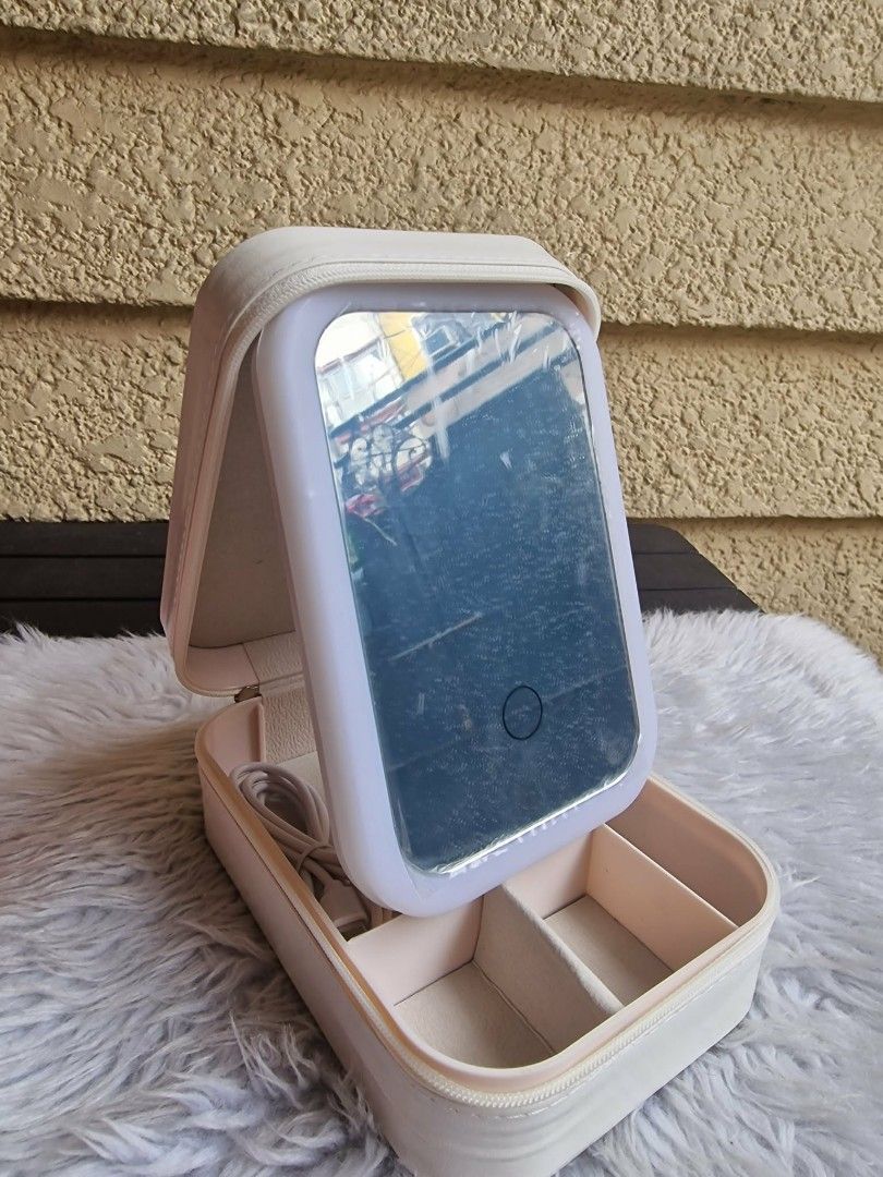 Portable Vanity Kit Mirror (White) (Category: Makeup) located in Quezon City. Submitted by floreskari78555 (Listing ID 1442272816, Image 1). Description: Portable Vanity Kit Mirror (White) Pu leather (smooth)✅ LED Ring Light✅ Encircles the mirror to provide shadow-free, even facial illumination. Smart Touch Dimmer✅Central touch button controls the light power and adjustable brightness. Storage Compartments✅ Divided lower tray neatly separates jew