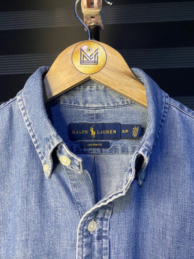 Ralph Lauren Button Down Custom Fit Denim (Category: Tshirts & Polo Shirts ) located in Cebu City. Submitted by nardcen (Listing ID 1442299955, Image 2). Description: - Classic blue denim shirt from Ralph Lauren - Custom fit, size S/P - Iconic polo player logo embroidered on chest - Button-down collar and button cuffs - Versatile for casual wear or layering - Easy to style with jeans or chinos.