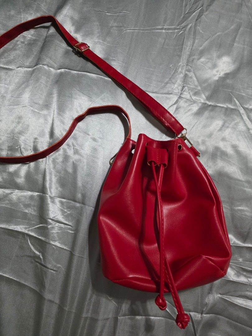 Red drawstring bucket bag (Category: Luxury Bags & Wallets) located in Pasig City. Submitted by plussizedpixie (Listing ID 1442227506, Image 2). Description: used for 2 hours only.