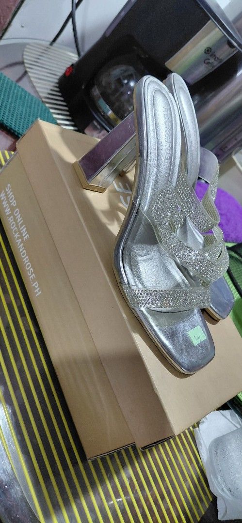Rock & Rose Silver Embellished Block Heels (Category: Heels) located in Manila. Submitted by snowice08 (Listing ID 1442303566, Image 2). Description: - Silver sandals with sparkly straps - Trendy square toe design - Chunky clear block heel for added height - Perfect for elevating any outfit - Size 37 - Includes original box and tissue paper.